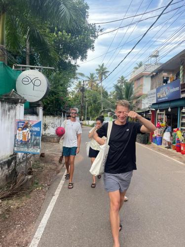 a group of people walking down the street at HostelExp, Varkala - A Beach Town Hostel in Varkala