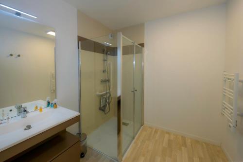 a bathroom with a shower and a sink at Résidence Goélia Le Phare in Le Tréport