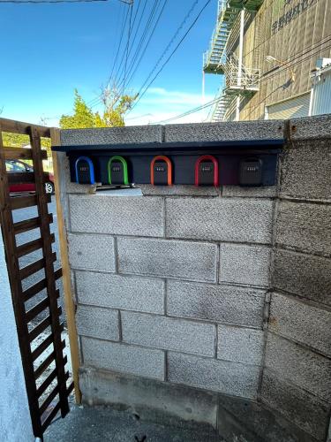 a train on a wall next to a fence at Denim-yado Ken-健- in Tamano