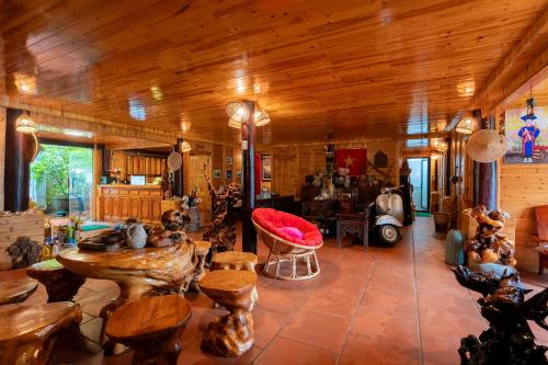 a large living room with wooden walls and wooden floors at Eco Farmer House - Sapa Retreat in Sa Pa
