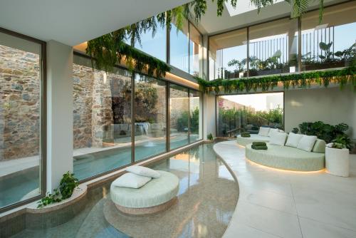 a house with a swimming pool and a living room at Royal Pearl Island Chios Hotel and Spa in Chios