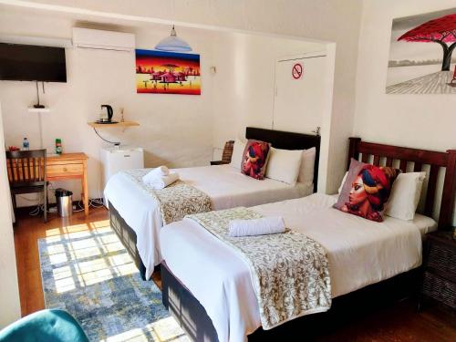Ένα ή περισσότερα κρεβάτια σε δωμάτιο στο Libra Lodge & Spa - Randburg, Johannesburg
