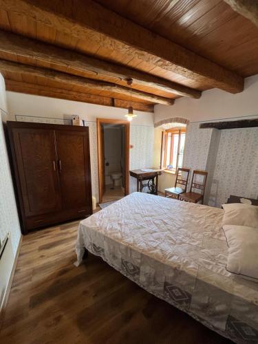 a bedroom with a large bed and wooden ceilings at Rooms Poli Luce - Room Pepa in Gračišće