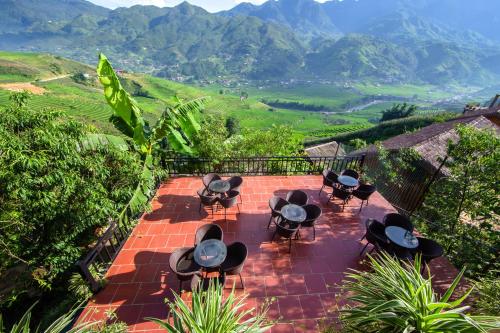 a group of chairs and tables on a brick walkway at Eco Farmer House - Sapa Retreat in Sa Pa