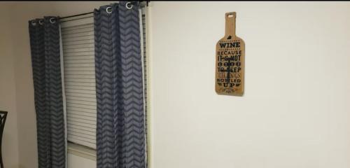 a window curtain with a sign hanging from it at Midtown Kingsport Townhouse in Kingsport