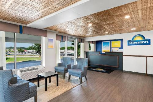 a waiting room with chairs and a flat screen tv at Days Inn by Wyndham Seneca-Clemson in Seneca