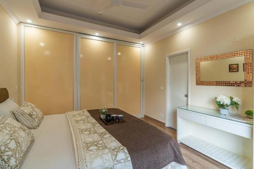 a bedroom with a large bed and a mirror at Pristine Pines by VEO - 8BR,2BR with Indoor Games at Kasauli in Kasauli