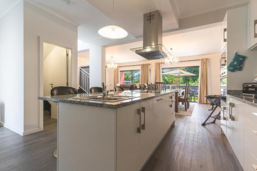 a kitchen with a sink and a counter top at Blue Outlook Garden by Atlantic Holiday in Água de Pena