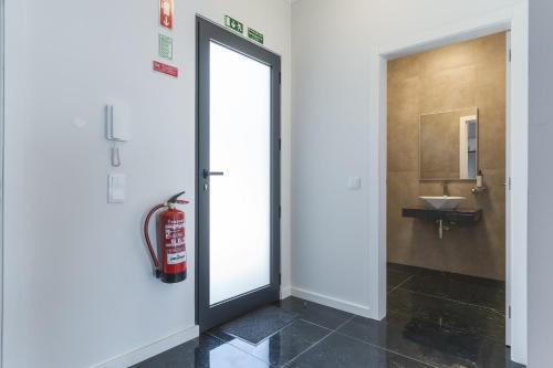a bathroom with a sliding door and a sink at Blue Outlook Garden by Atlantic Holiday in Água de Pena