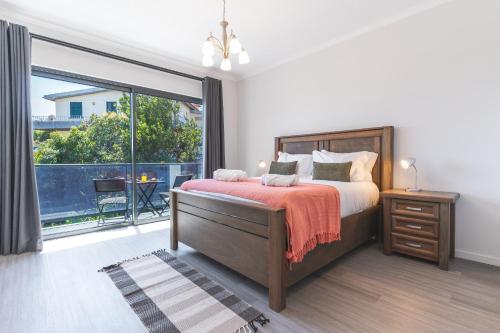 a bedroom with a bed and a large window at Blue Outlook Garden by Atlantic Holiday in Água de Pena
