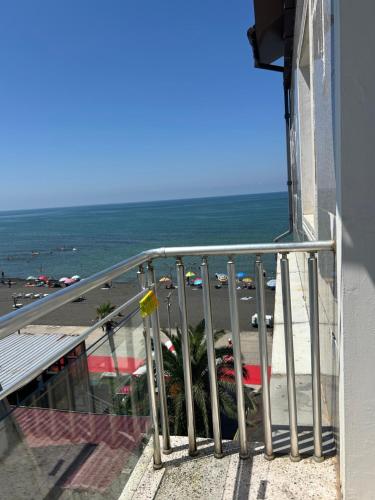 a balcony of a building with a view of the ocean at Hotel George in Ureki