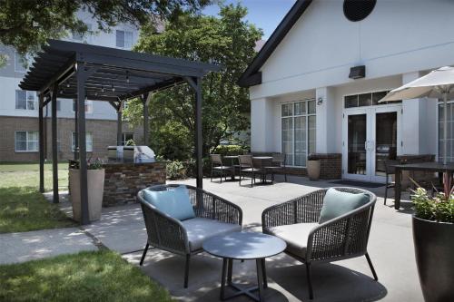acovered patio with chairs and tables and a table at Homewood Suites by Hilton Princeton in Princeton