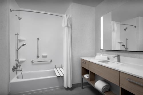 a white bathroom with a tub and a sink at Homewood Suites by Hilton Princeton in Princeton