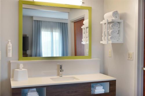 a bathroom with a sink and a mirror at Hampton Inn & Suites Tulsa/Tulsa Hills in Tulsa