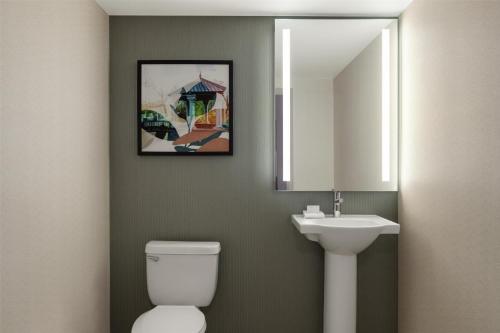 a bathroom with a sink and a toilet and a mirror at Hilton Garden Inn Atlanta Downtown in Atlanta