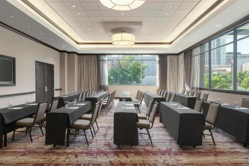 a conference room with tables and chairs and windows at Hilton Garden Inn Atlanta Downtown in Atlanta