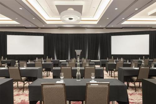 a conference room with tables and chairs and screens at Hilton Garden Inn Atlanta Downtown in Atlanta