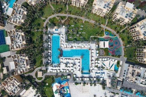 an aerial view of a resort with a swimming pool at DoubleTree by Hilton Resort & Spa Marjan Island in Ras al Khaimah