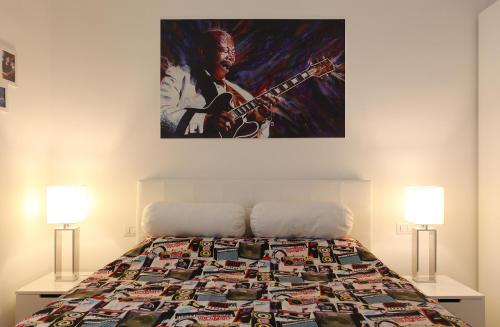 a bedroom with a bed with a painting on the wall at Big Johnny B in Rome