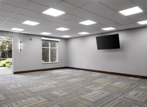 a large room with a flat screen tv on a wall at Homewood Suites by Hilton Akron/Fairlawn in Akron