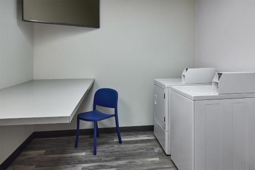a blue chair sitting next to a desk in an office at Hampton Inn Colby in Colby