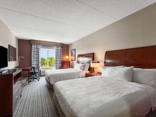 a hotel room with two beds and a television at Hilton Garden Inn Winchester in Winchester