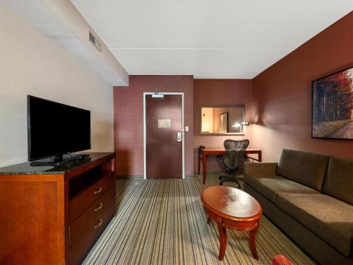 a living room with a couch and a flat screen tv at Hilton Garden Inn Winchester in Winchester