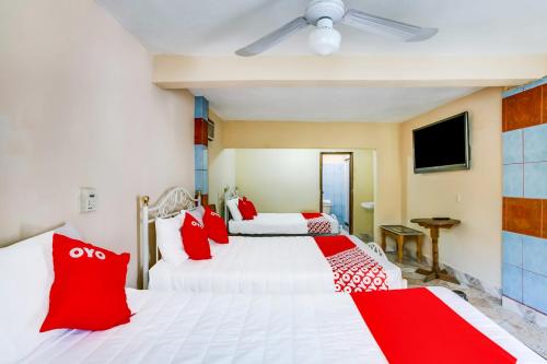 Ένα ή περισσότερα κρεβάτια σε δωμάτιο στο OYO Hotel Margarita