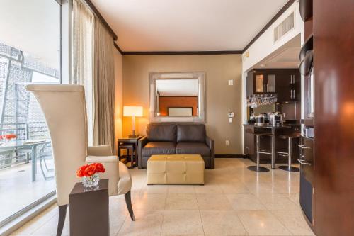 a living room with a couch and a chair at SBV Luxury Ocean Hotel Suites in Miami Beach