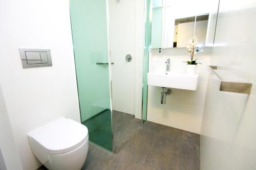 a bathroom with a toilet and a sink at The Landing Port Hedland in Port Hedland