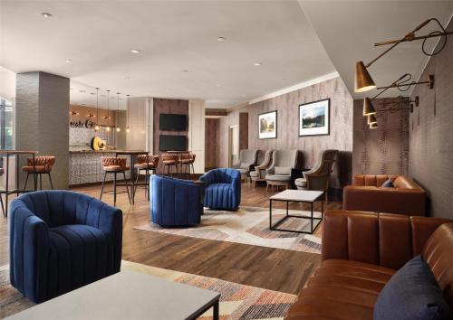 a lobby with blue furniture and a bar at DoubleTree by Hilton Hotel Nashville Downtown in Nashville