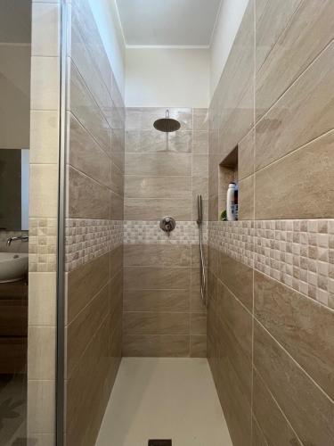 a shower with a glass door in a bathroom at Dimora dei Climiti in Floridia