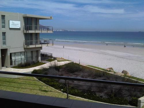 a view of the beach from a balcony of a condo at Lagoon Beach Hotel & Spa in Cape Town