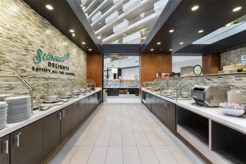 a restaurant kitchen with a counter with dishes at Embassy Suites by Hilton Anaheim-Orange in Anaheim