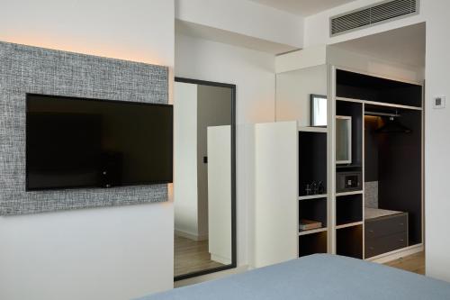 a bedroom with a flat screen tv on a wall at INNSiDE by Meliá Barcelona Apolo in Barcelona