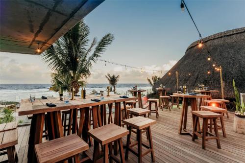 a restaurant on the beach with tables and chairs at Radisson Blu Poste Lafayette Resort & Spa (Adults Only) in Poste Lafayette
