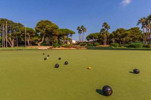 a group of bowling balls on a green field at AluaSoul Menorca - Adults Only in S'Algar