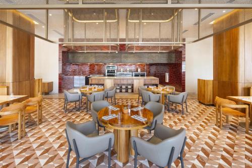 a restaurant with tables and chairs and a kitchen at Waldorf Astoria Costa Rica Punta Cacique in Playa Hermosa