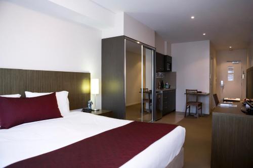 a hotel room with a bed and a tv at Quest Shepparton in Shepparton