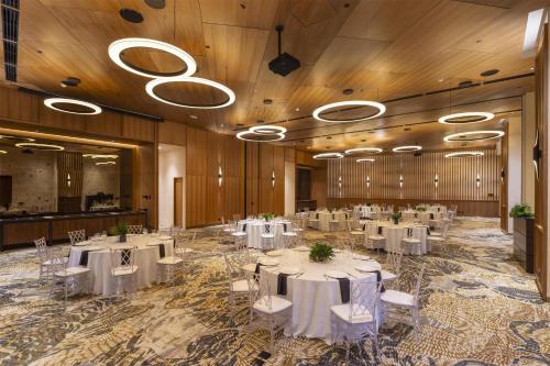 a banquet hall with white tables and white chairs at Waldorf Astoria Costa Rica Punta Cacique in Playa Hermosa