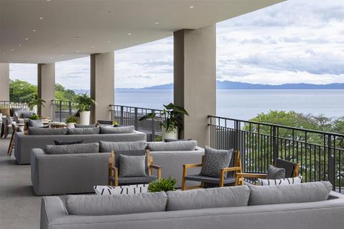 a lobby with couches and chairs and a view of the ocean at Waldorf Astoria Costa Rica Punta Cacique in Playa Hermosa
