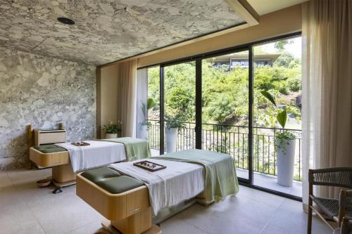 a hospital room with two beds and a window at Waldorf Astoria Costa Rica Punta Cacique in Playa Hermosa