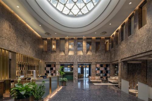 a lobby with a large skylight in the ceiling at Hilton Turin Centre in Turin