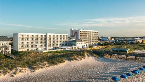 a hotel on the beach next to the water at Golden Sands Carolina Beach Oceanfront, Tapestry by Hilton in Carolina Beach