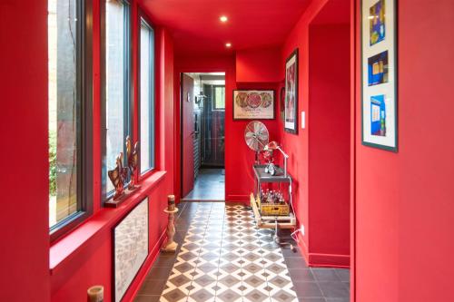 a red hallway with red walls and a tile floor at Au Bout du Chemin - Vue Chateau in Vitrac