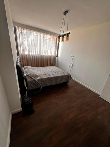 a small bedroom with a bed and a window at Grand Sapphire B Block 8th Floor with Stunning Sea View in Kataliondas