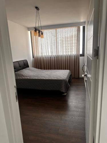 a bedroom with a bed and a window at Grand Sapphire B Block 8th Floor with Stunning Sea View in Kataliondas