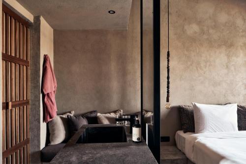 a bedroom with a bed and a table next to a couch at Cook’s Club El Gouna (Adults Only) in Hurghada