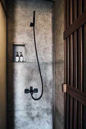 a bathroom with a shower with two bottles on a wall at Cook’s Club El Gouna (Adults Only) in Hurghada