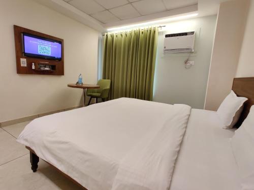 Un ou plusieurs lits dans un hébergement de l'établissement Oasis Inn